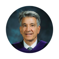 A picture of David Tanovich in a circular border.