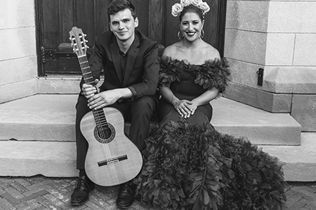 SoCA alumni Amelia Daigle, soprano and Daniel Turner, guitar sitting on front steps