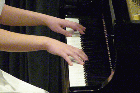 Student playing piano in recital