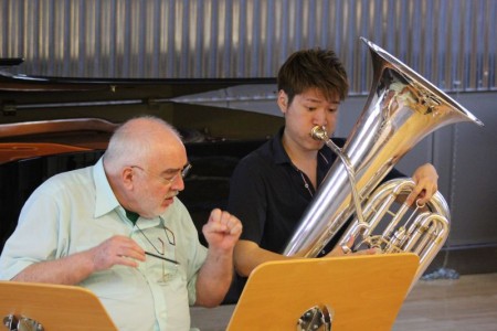 Roger Bobo working with a student at a camp in Germany