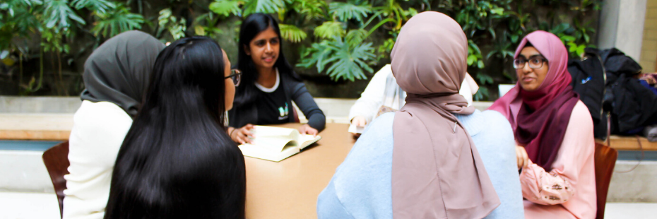 girls talking around a table