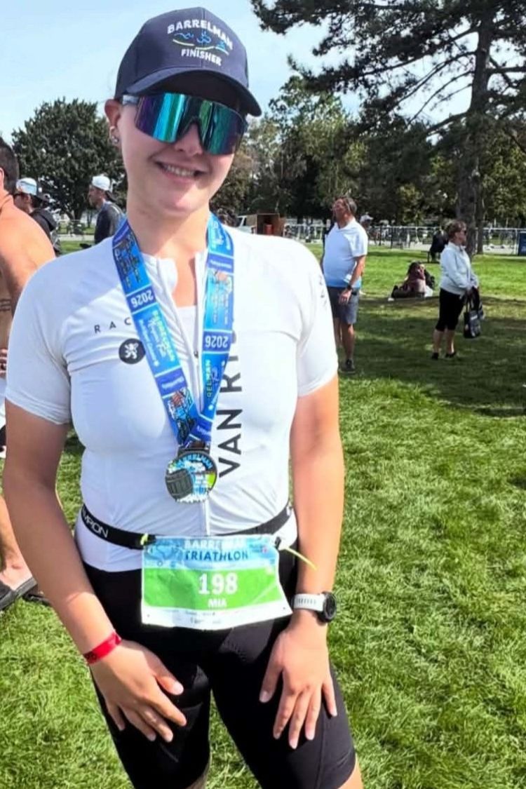 Mia Kairouz with her medal after finishing a triathlon