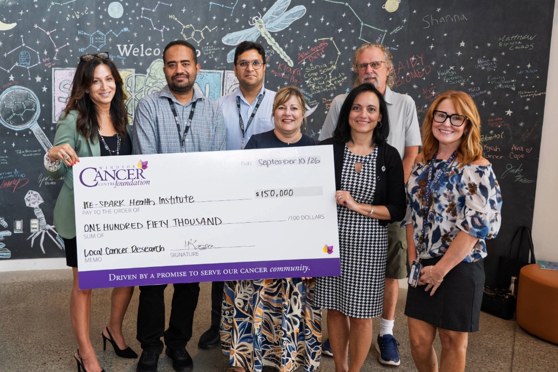 Participants hold up giant cheque