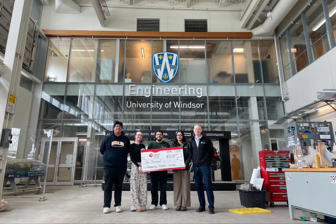 Members of the Engineering Students' Society with Dean Bill Van Heyst present cheque to United Way