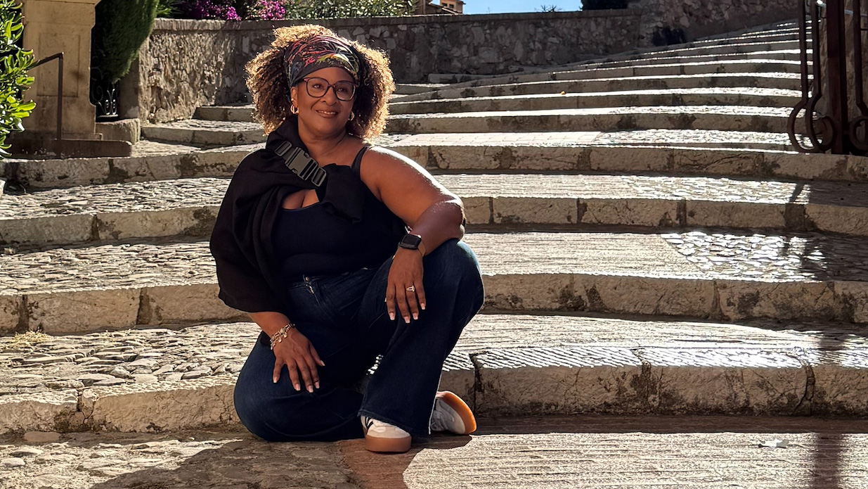 Photo of Dianne Bondy sitting on steps.