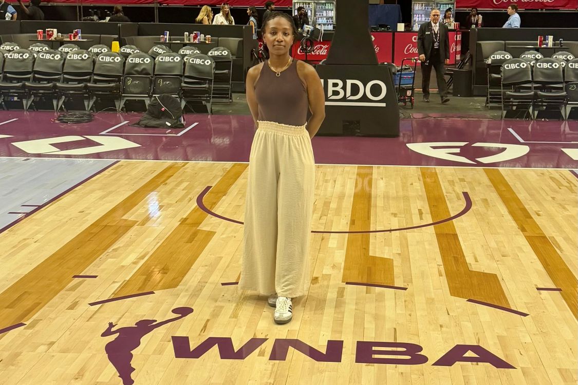 Eve Uwayesu on the court with the WNBA logo