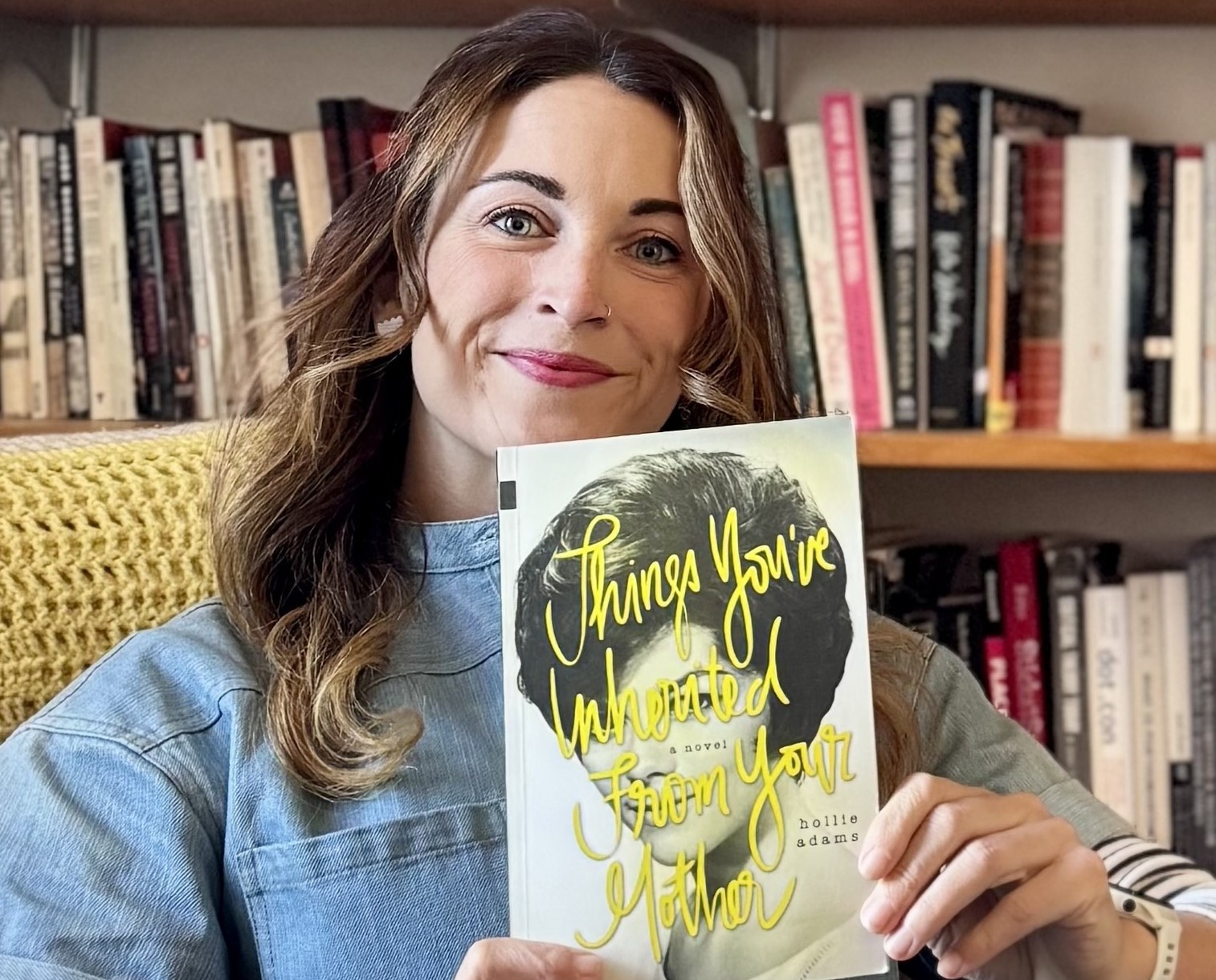 Hollie Adams holding her book