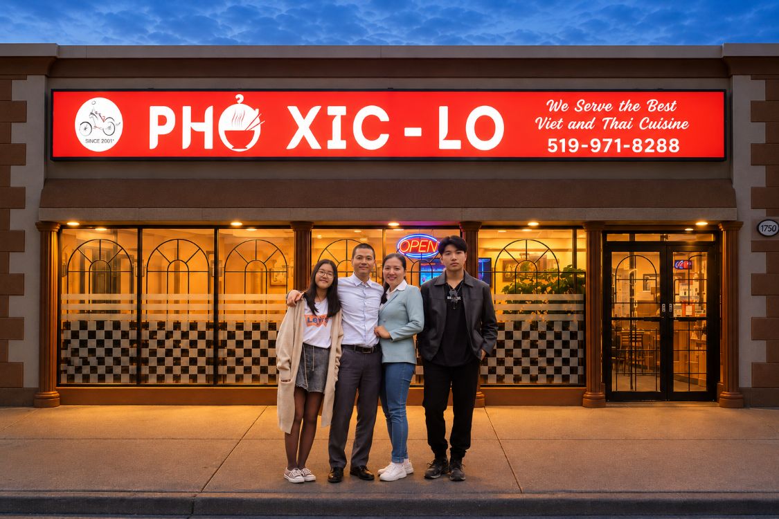 Giang and her husband and two children in front of the Pho Xic Lo restaurant