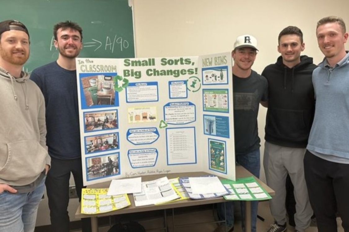 Five students with poster board for recycling service learning project