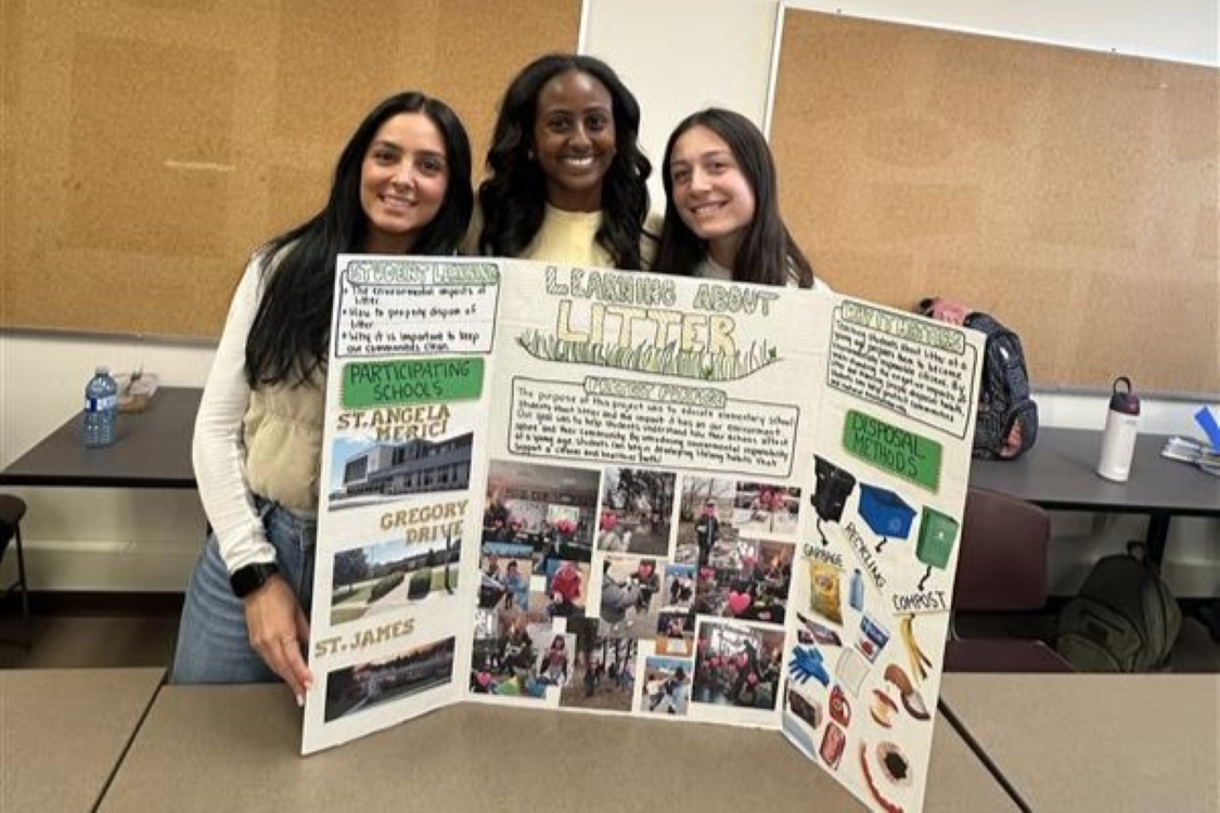 Three students behind their poster board for Learning About Litter