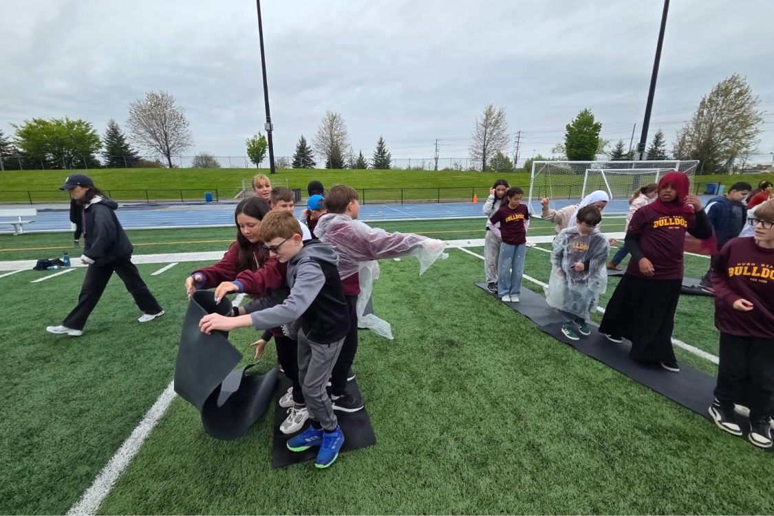 Children play games on the field at alumni stadium