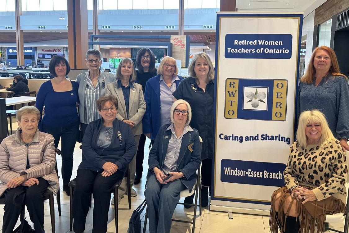 A group of women with a banner for the Retired Women Teachers' Organization