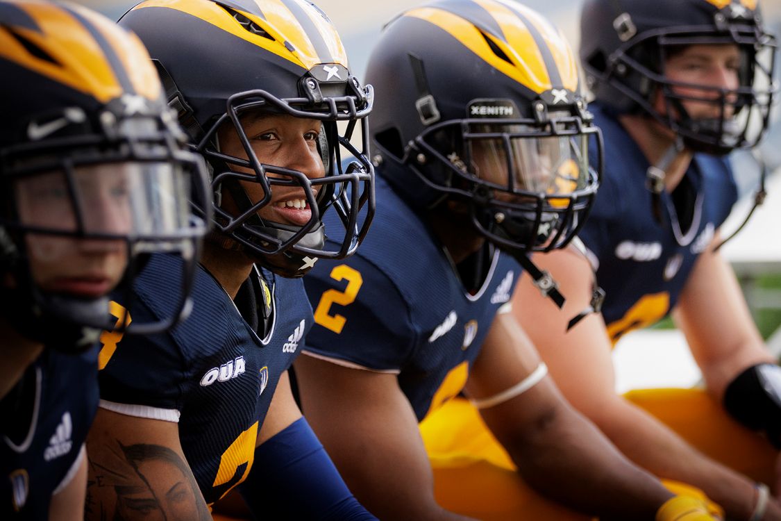 Four football players in helmets