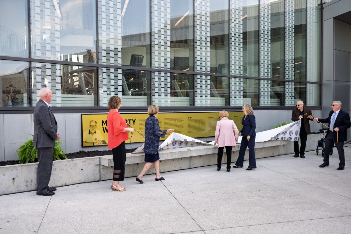 A group of people unveils the Moriarty Way plaque