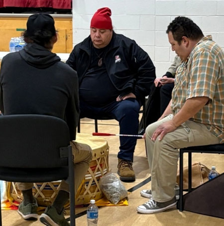Members of Aamjiwnaang community gather around a traditional drum