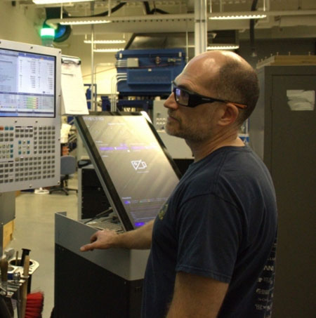 Technician using 3D printing machine at UWindsor