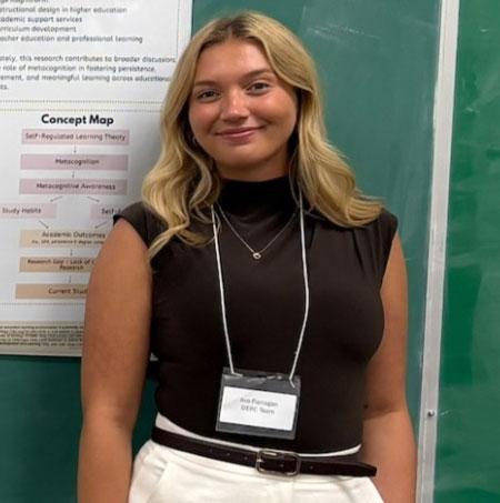 Ava Flanagan stands in front of her academic poster