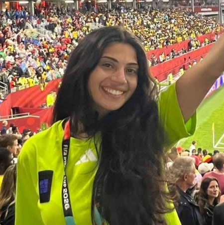 Casandra Asoufi with her arm raised in the World Cup stadium in Toronto