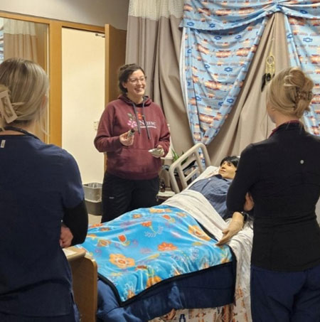 Sara Williams stands with students in an an Indigenous simulation clinic