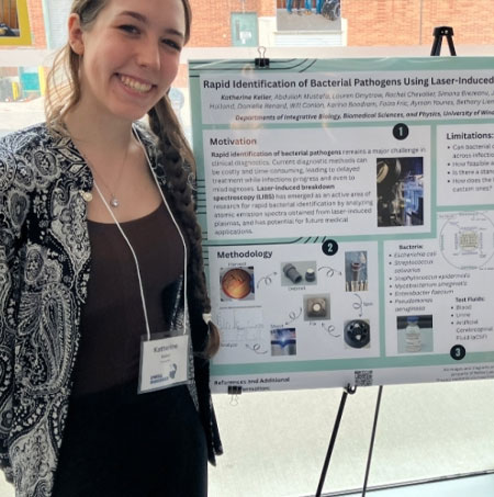 Kitti Keller standing beside her research poster
