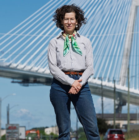 Lee Rodney standing in front of the new Gordie Howe Bridge
