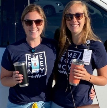 Destiny Cadarette stands beside a nursing colleague outside in front of a truck
