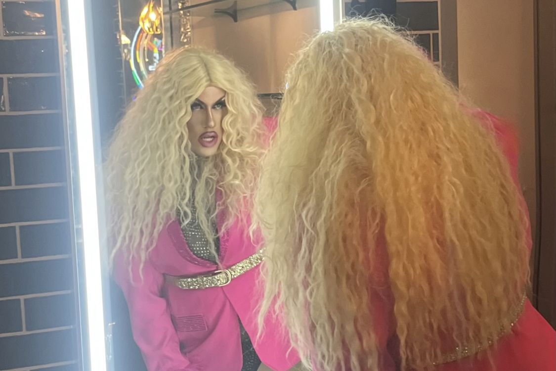 Cole Fortier as Epoxy the drag queen posing in a mirror