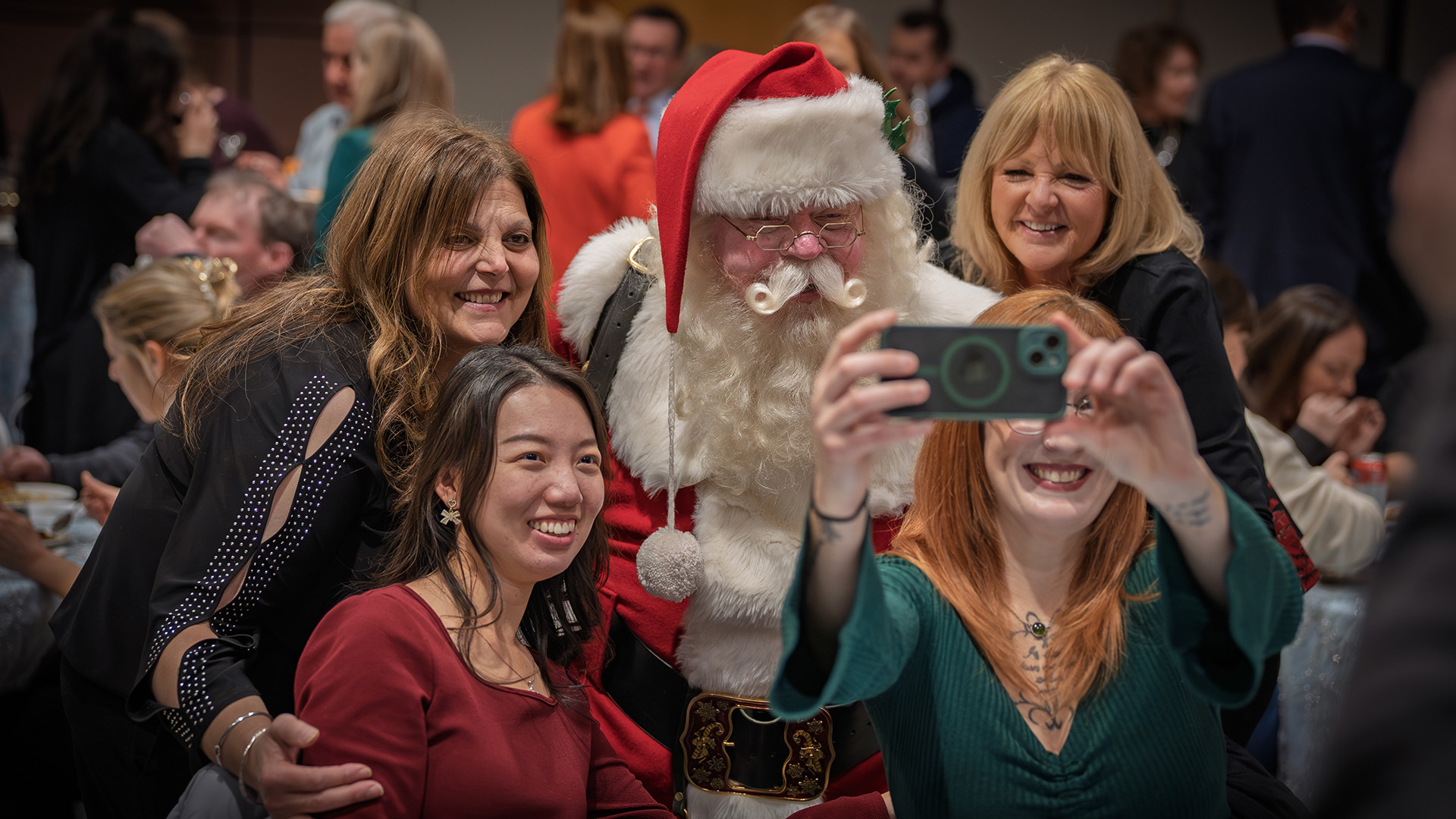 Santa Bruce takes part in selfies with employees at the recent Faculty and Staff Holiday Gathering. (PHOTO BY KYLE ARCHIBALD/University of Windsor)
