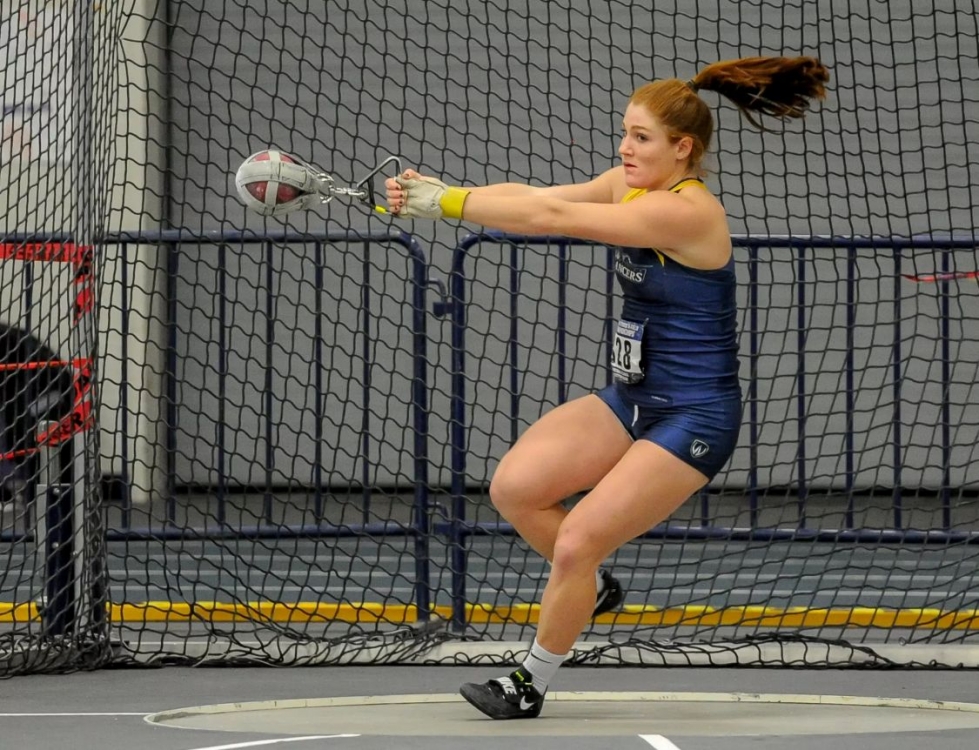 Sarah Mitton in Lancer jersey competing at shot put