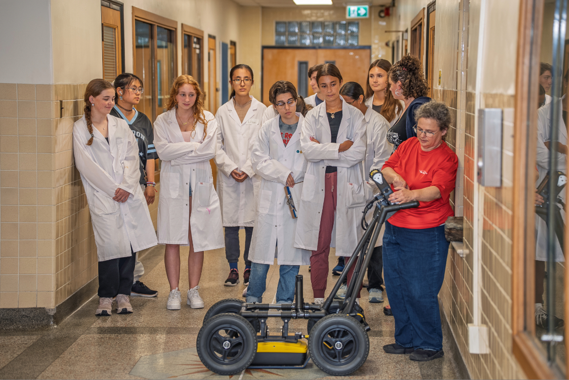 High School students in lab coats at Science Academy