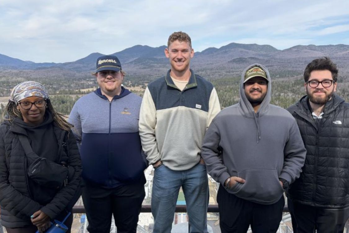 Group of people in front of Lake Placid ski jump