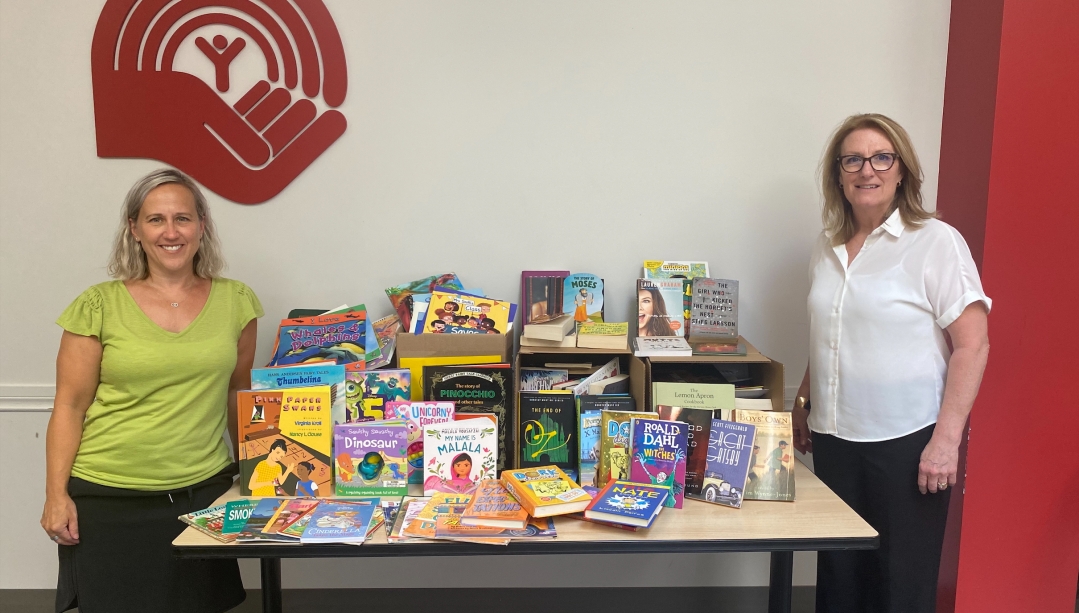 University of Windsor staff members Sara McNorton and Sandra Neposlan at a book drive for the United Way