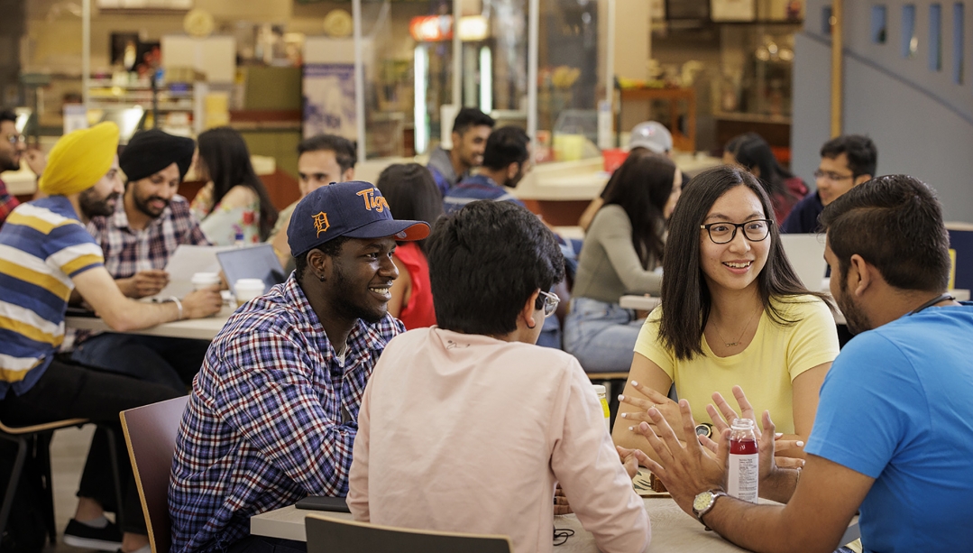 Student sitting in dining facility.