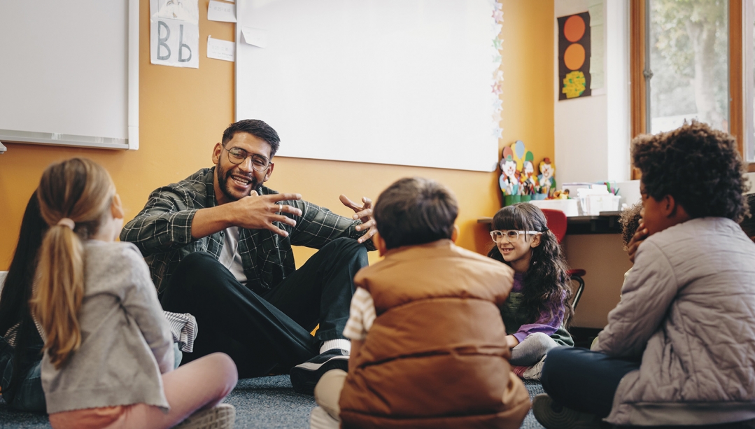 Teacher in classroom interacting with students.