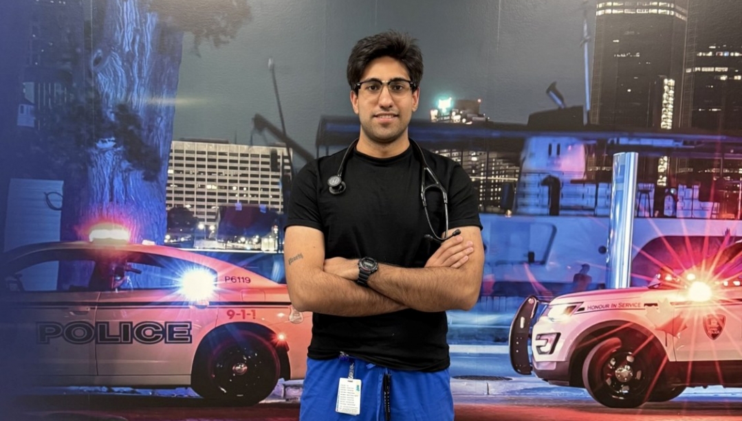 Ali Mozafari stands in front of two emergency vehicles during training at CAF base in Windsor.