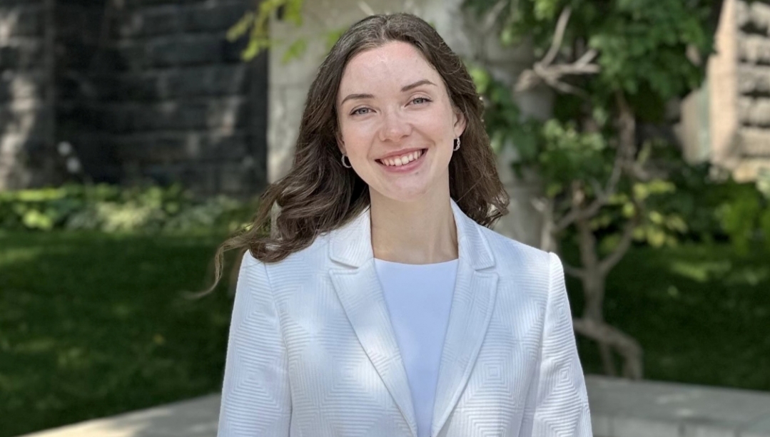 Rebecca Balasa stands outside in a green space