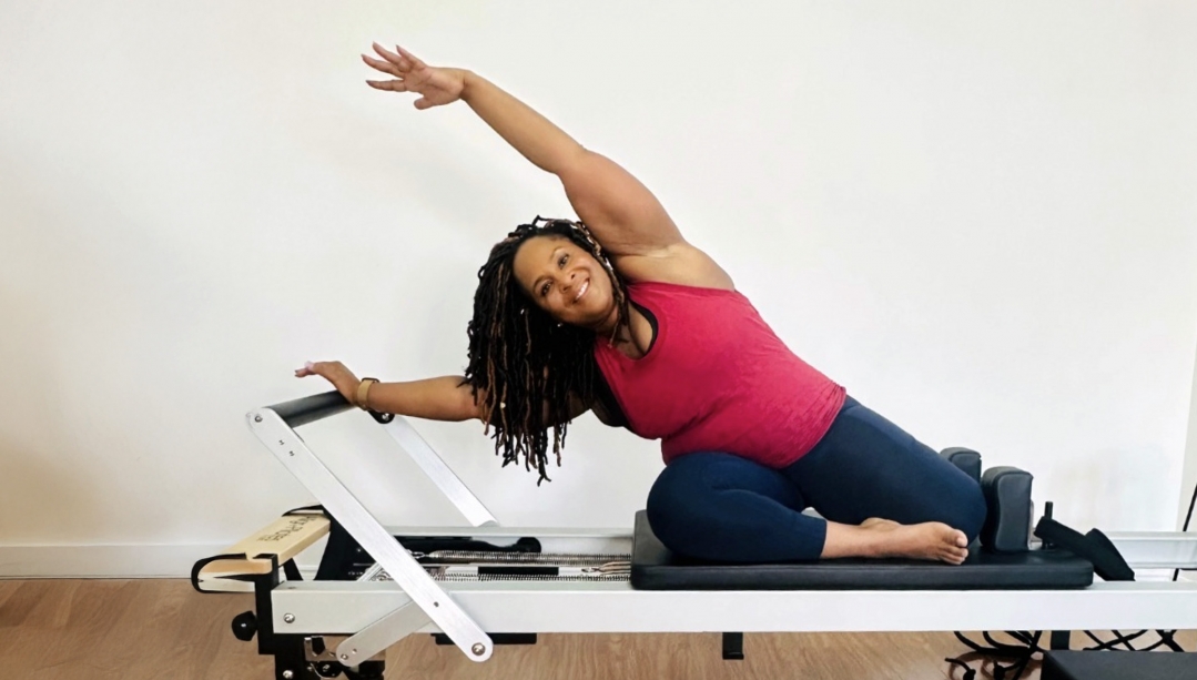 Dianne Bondy in a yoga pose on a training machine.