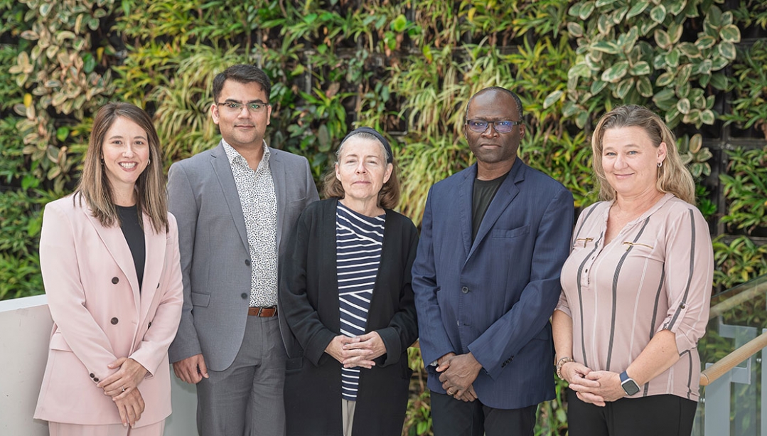 Members of the IJEDID Circle stand in front of greenery background in the Nursing Faculty building on UWindsor campus