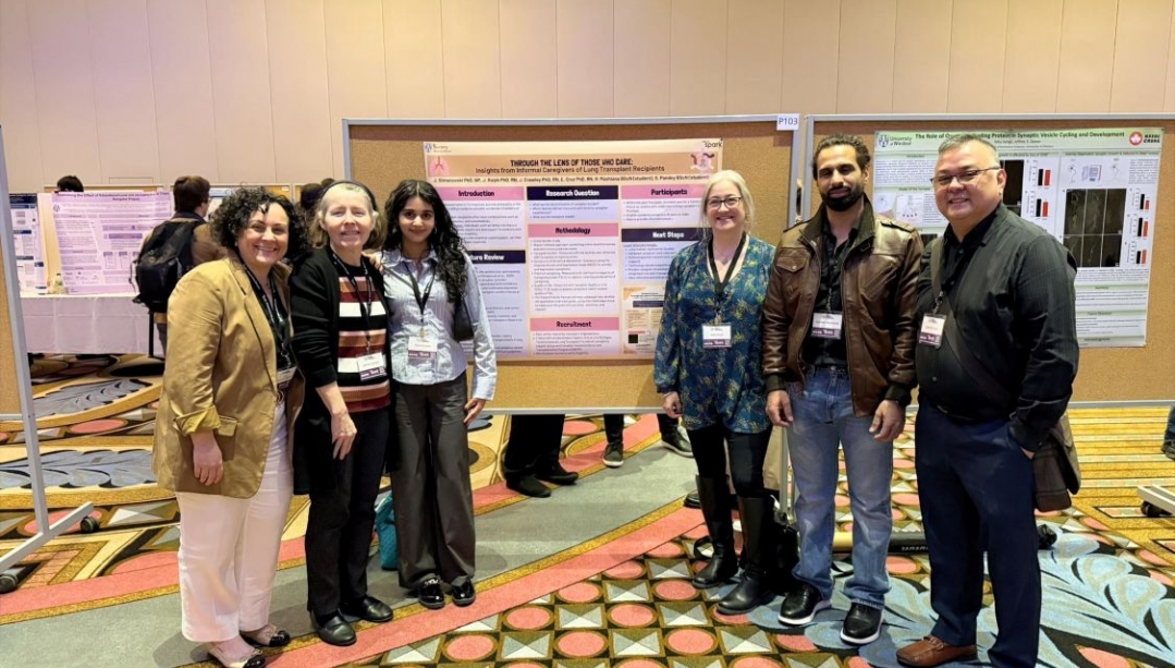 Jane and her team of colleagues and students stand with their poster at the WESPARK conference