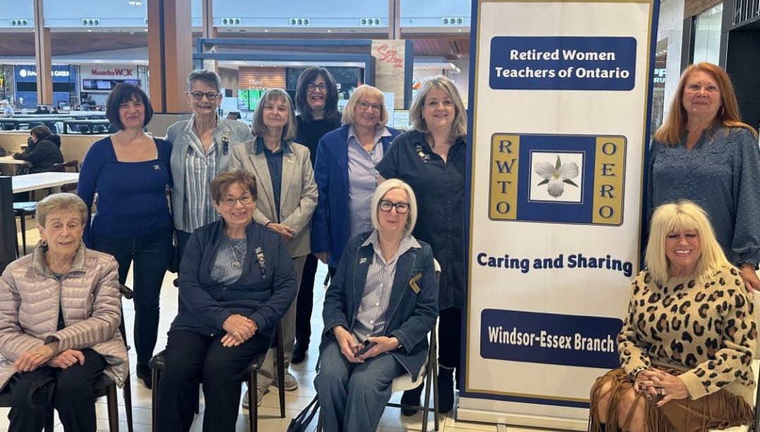 A group of women with a banner for the Retired Women Teachers' Organization