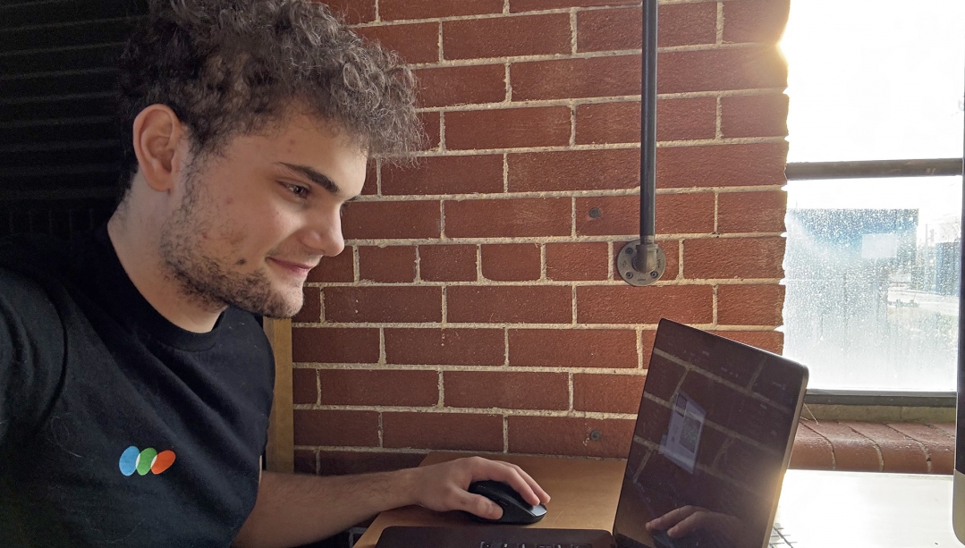 Jett Shields using laptop for video editing.