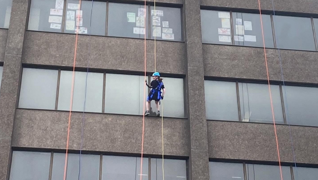 Kaitlin Ferraro rappels down CIBC Building on Riverside Drive in Windsor, Ontario.