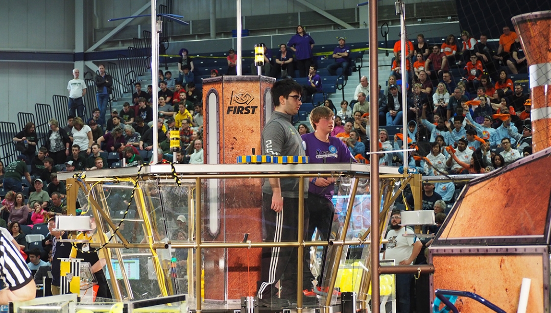 Students work on a robot in front of a crowd at the St. Denis Centre at UWindsor