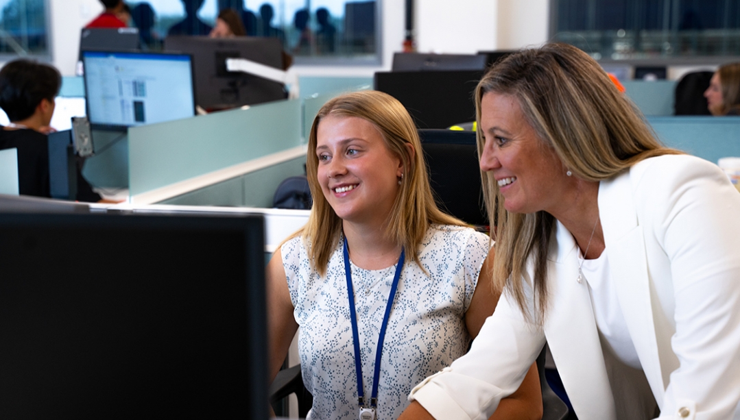 student and instructor seated at a computer