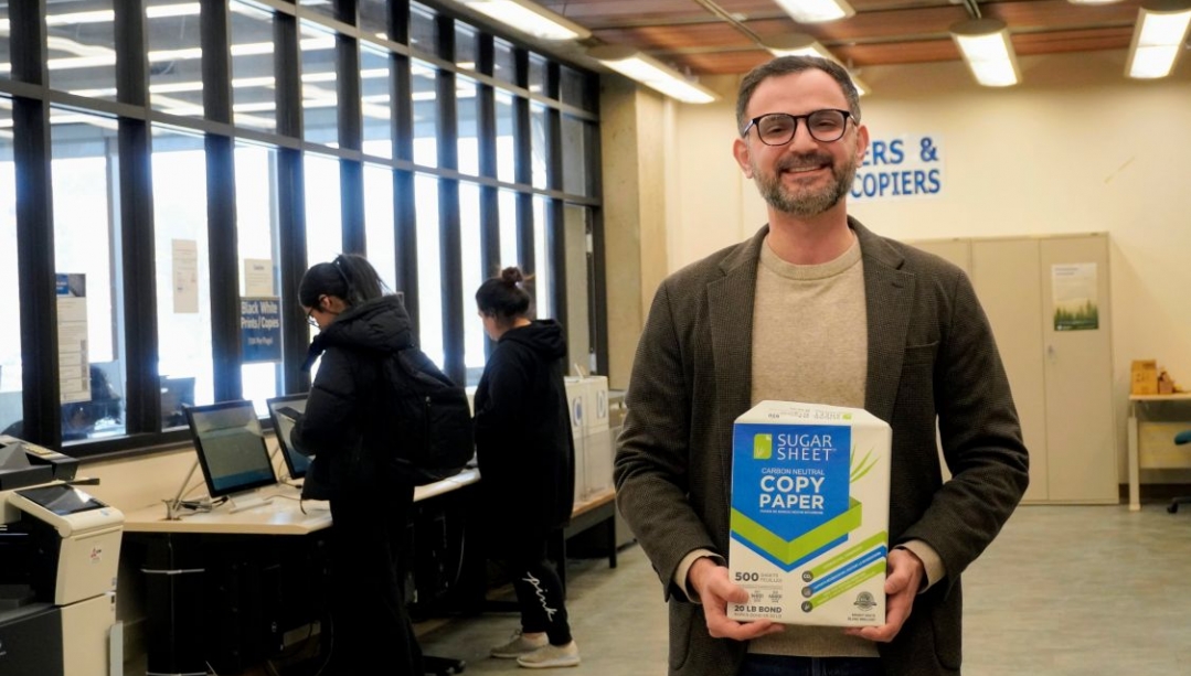 Roger Reka holding a packet of sugarcane based paper