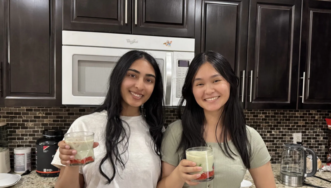 Sona Regonda &amp; Linda Nguyen, co-leads on The Cozy Kitchen Cookbook pose with a refreshing iced strawberry lemon matcha latte. 