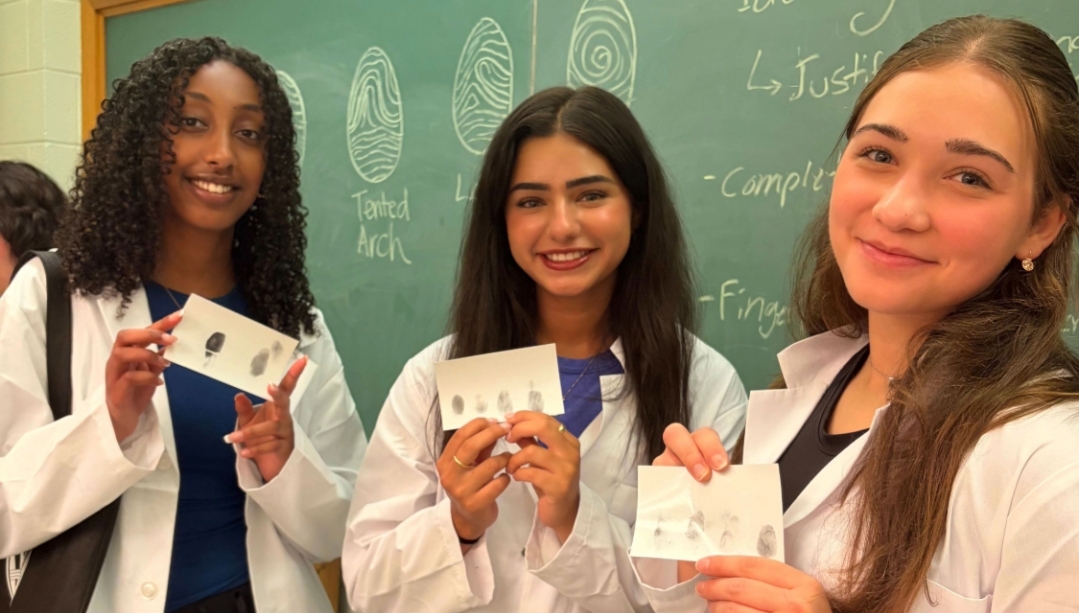 Three students in lab coats