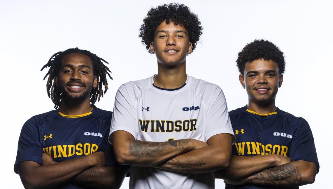 Lancer athletes standing together with arms crossed.