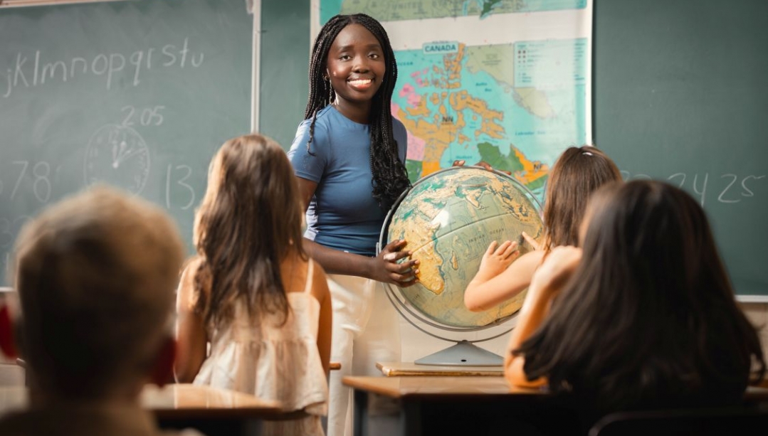 Student teacher in front of elementary school children
