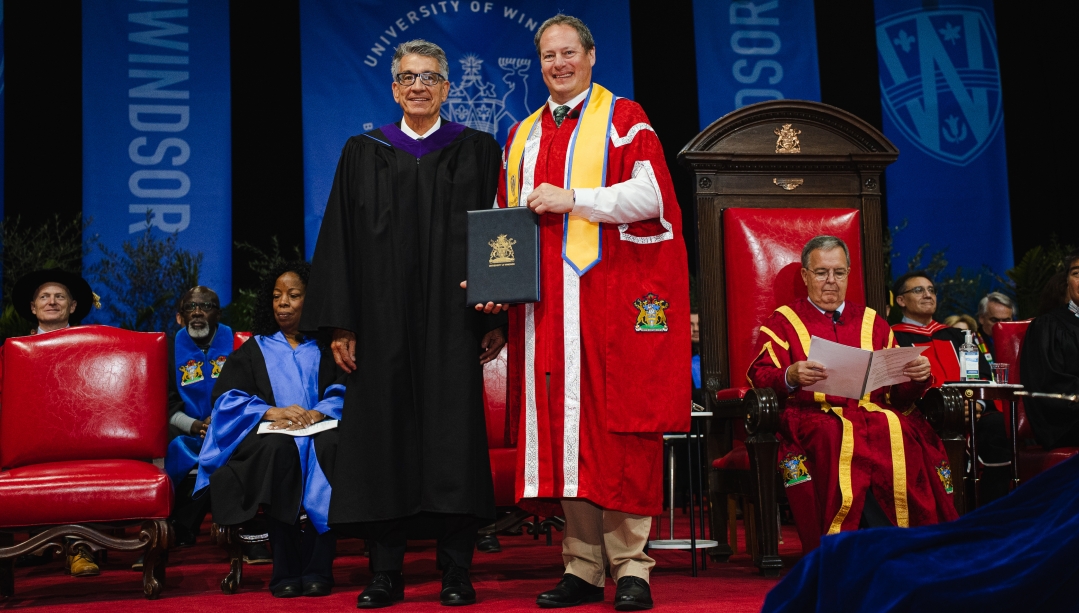 University of Windsor President J.J. McMurtry, right, presents Prof. David Tanovich with the title of Distinguished University Professor during the Fall 2025 Convocation ceremony on Oct. 16. (JOHN-PAUL BONADONNA/University of Windsor) 